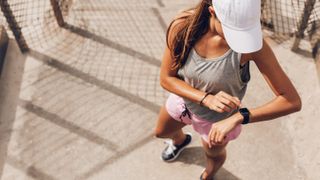 Woman checking notifications on a sports watch outside